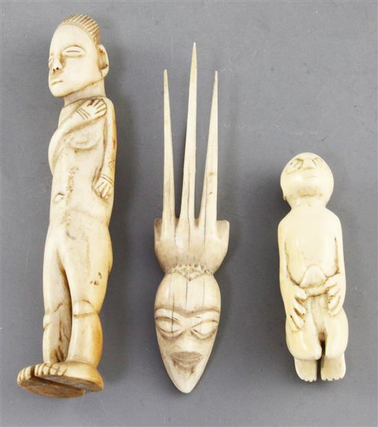 Two West African ivory storyteller figures, c.1900 and a hair ornament carved with a mask, largest 16cm